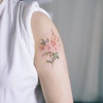 Beautiful and delicate flower on the left arm