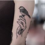 Bird on a hand tattoo by Jonas Ribeiro