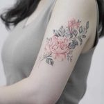 Black and red rose tattoo on the left arm