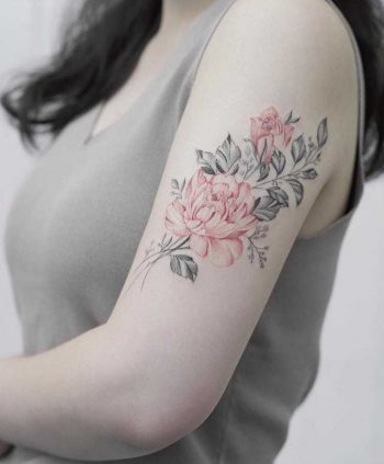 Black and red rose tattoo on the left arm