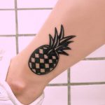 Black and white pineapple tattoo