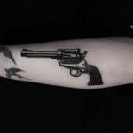 Black and white revolver tattoo done at BK Ink Studio
