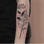 Black and white wildflowers on the forearm