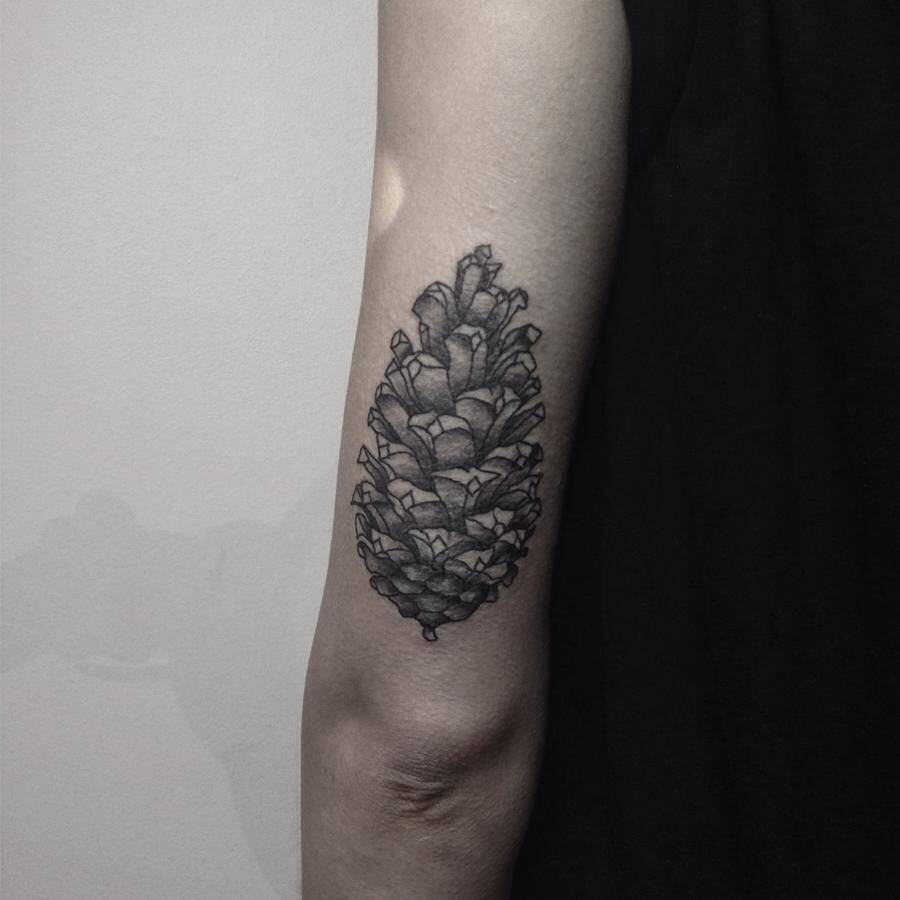 Black cone tattoo on the arm