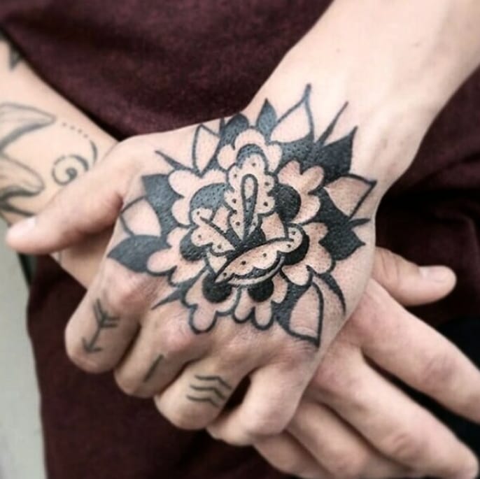 Black flower tattoo by Jay Lester