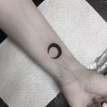 Black moon tattoo on the wrist