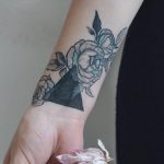 Black triangle and rose tattoo