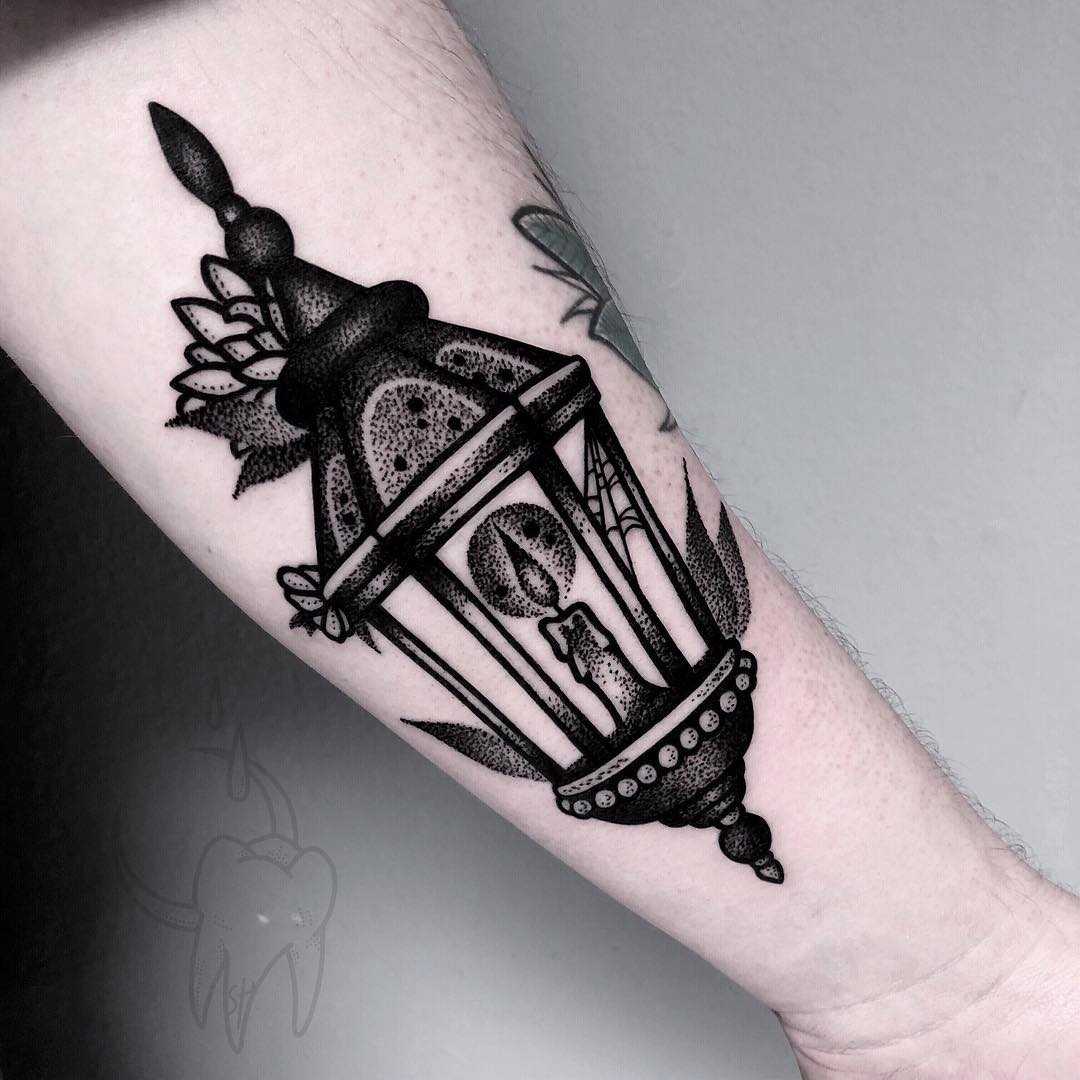 Blackwork lantern tattoo on the forearm