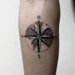 Circular world map and compass rose tattoo
