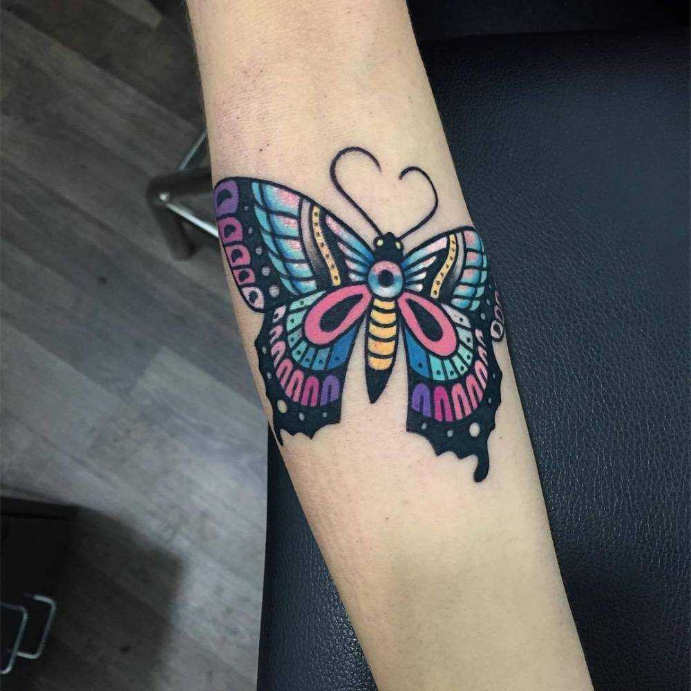 Colorful butterfly tattoo by Raro
