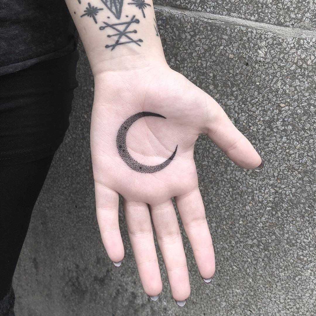 Crescent moon tattoo on the palm