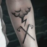 Crossed axes and rain cloud tattoo