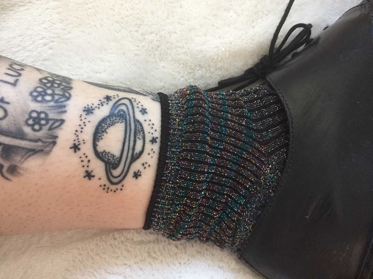 Cute stick and poke Saturn tattoo