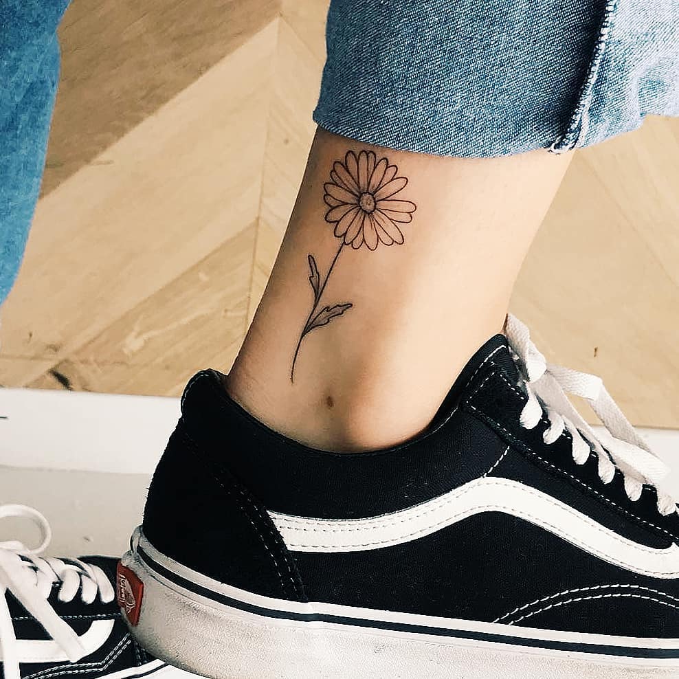 Daisy tattoo on the ankle