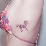 Dot-work horse tattoo on the rib
