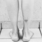 Dot-work style heart tattoo on the right calf