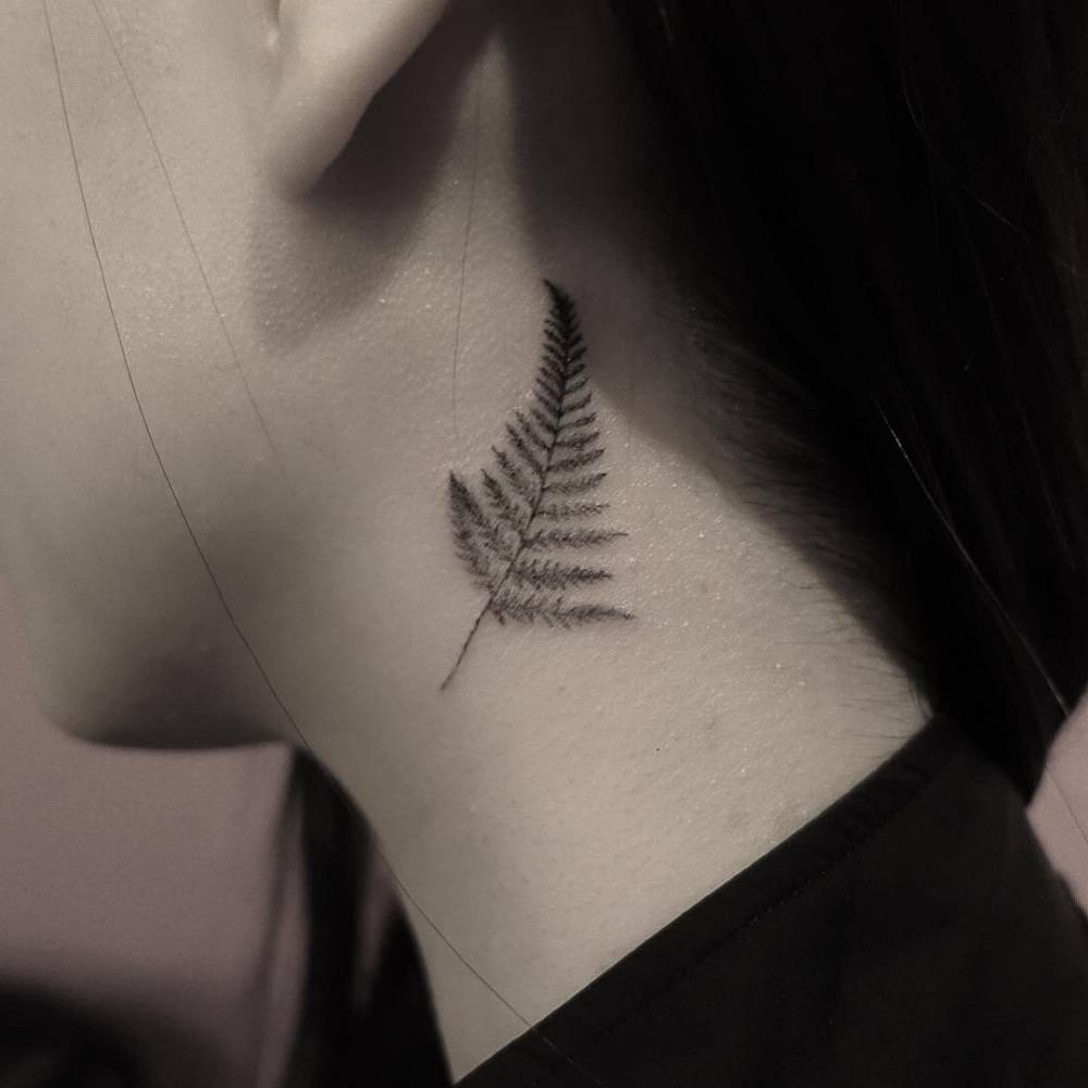 Fern leaf tattoo on the neck