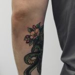 Flowers and snake on the forearm
