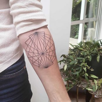 Geometric black tattoo on the left forearm