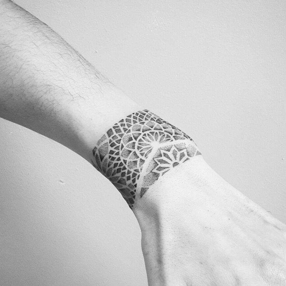 Geometric dot-work bracelet tattoo
