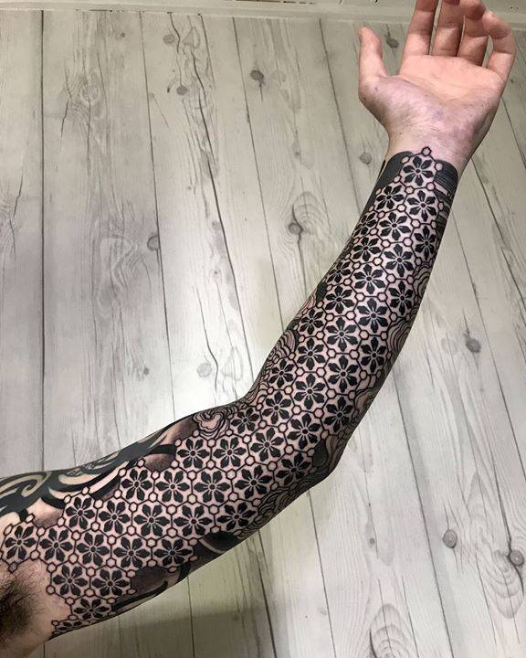 Geometric sleeve tattoo by Nissaco