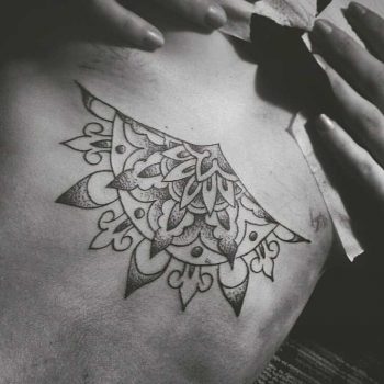 Half mandala sternum tattoo
