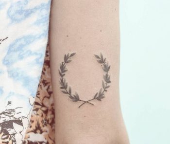 Hand-poked laurel wreath tattoo