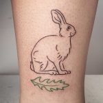 Hand-poked rabbit and leaf tattoo