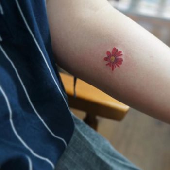 Hand-poked red flower by tattooist baka