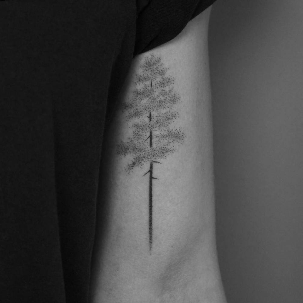 Hand-poked tree tattoo on the bicep