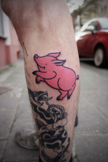 Happy jumping pig tattoo
