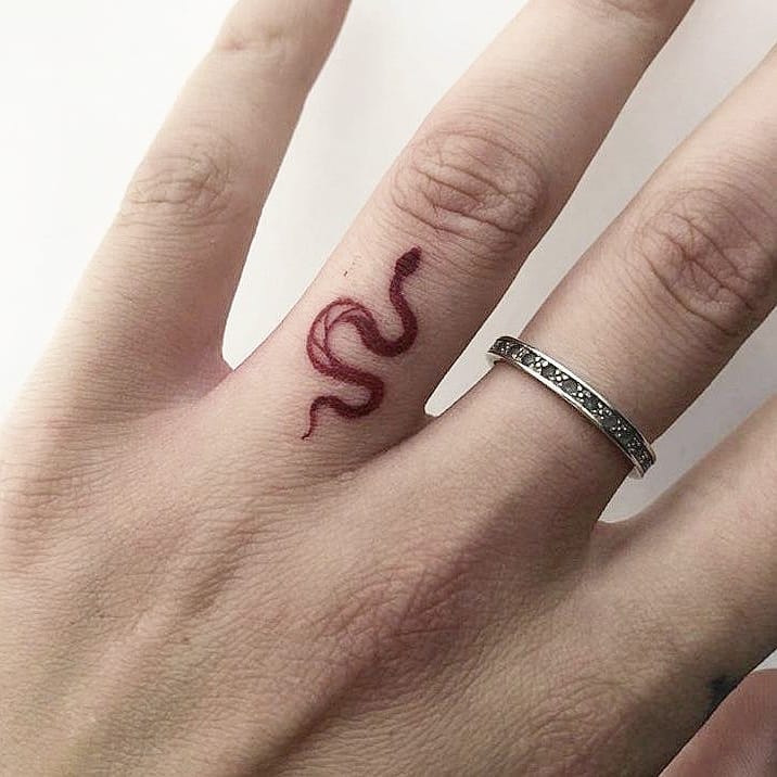 Little red snake tattoo on the finger