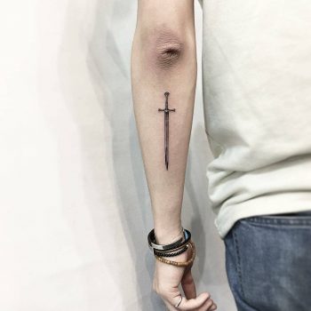 Little sword tattoo on the forearm