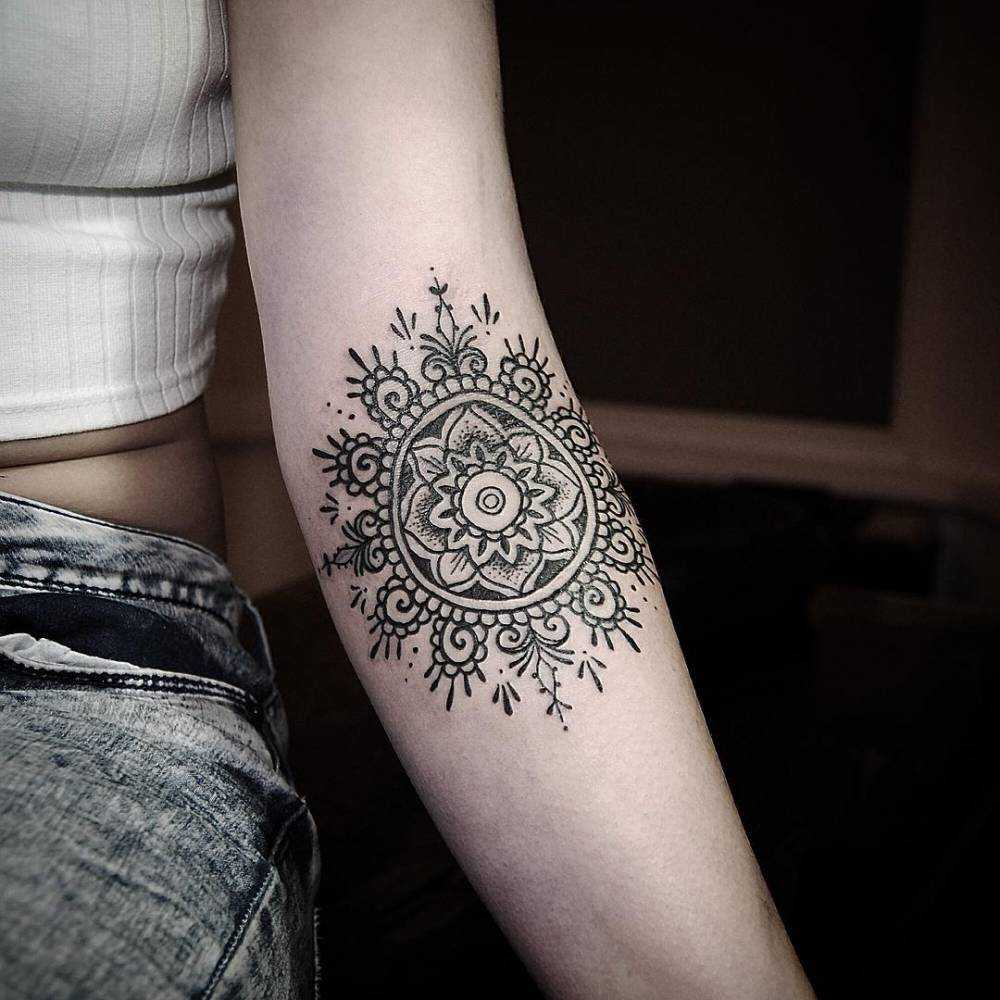 Mandala tattooed on the elbow by Manu