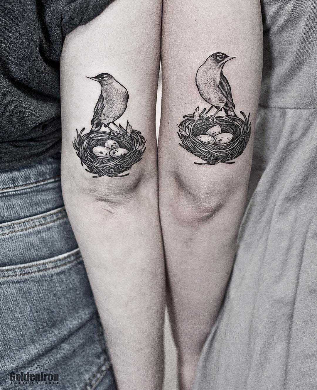 Matching Robin tattoos by Jas