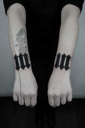 Matching black tattoos on both wrists