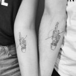 Matching cacti tattoos on forearms
