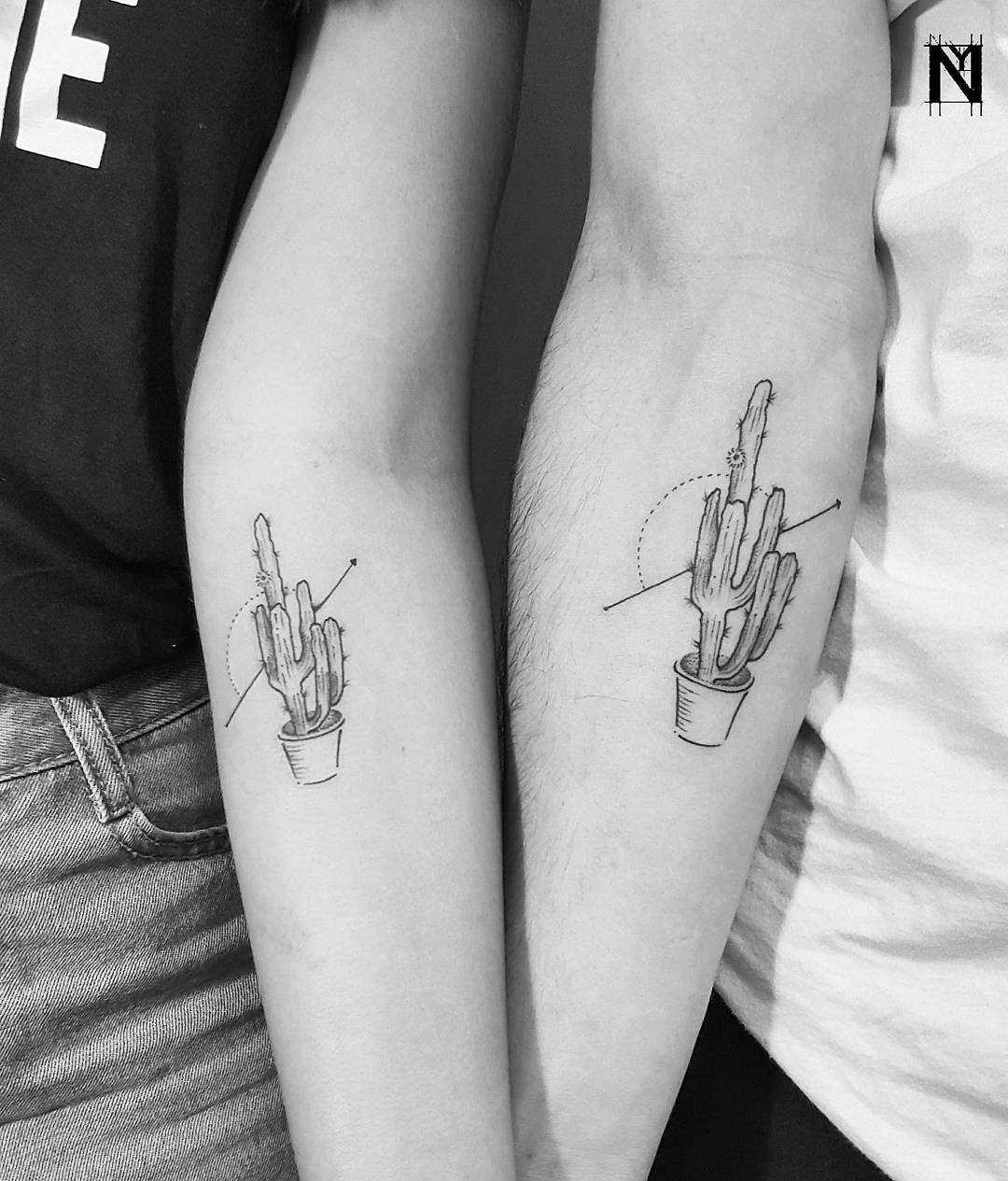 Matching cacti tattoos on forearms