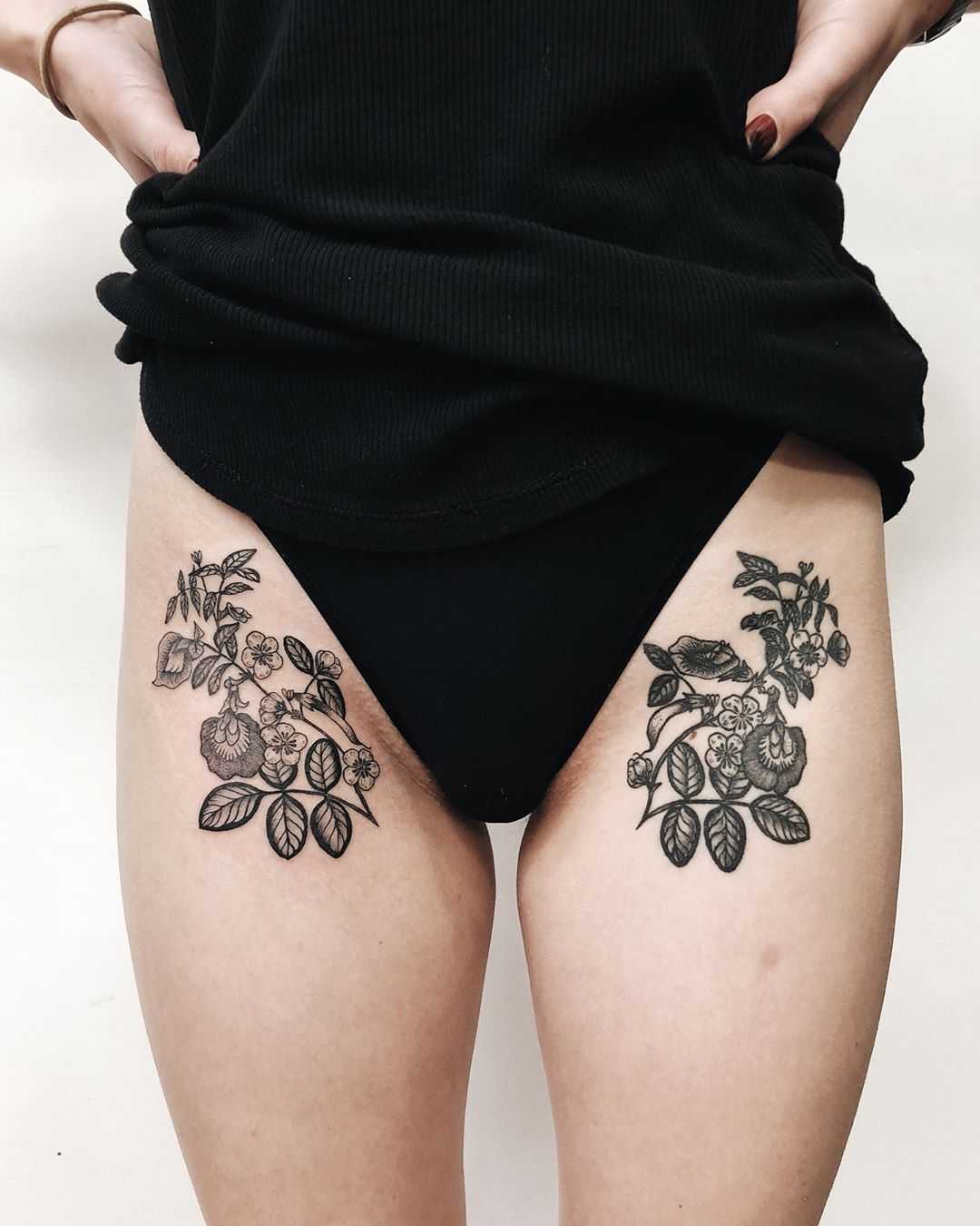 Matching flower tattoos on both hips