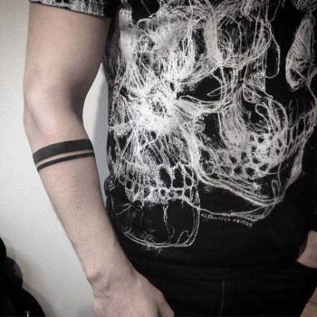 Minimalist armband tattoo on the forearm