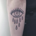 Minimalist crying eye tattoo