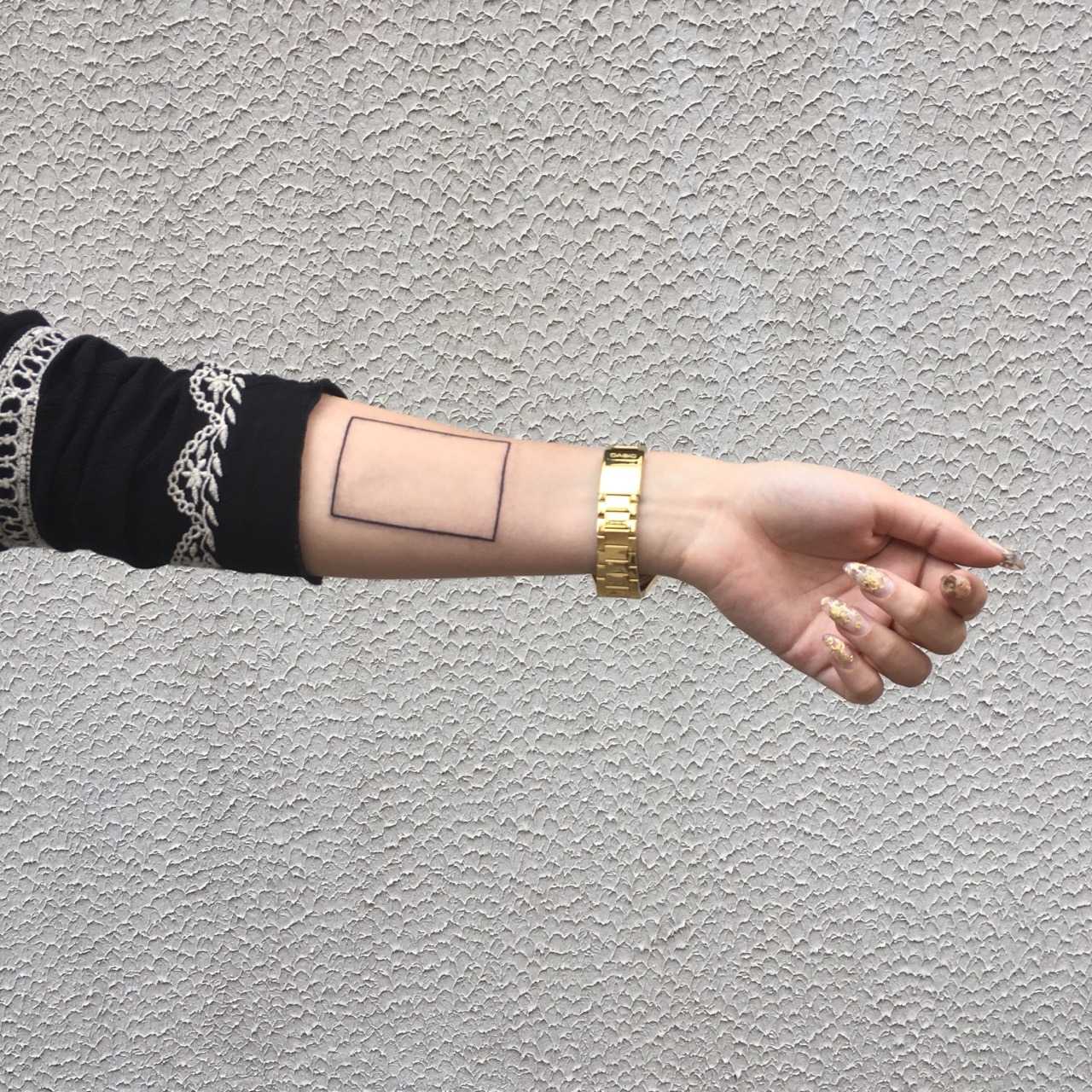 Minimalist rectangle tattoo on the wrist