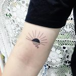 Minimalist sunrise tattoo on the arm