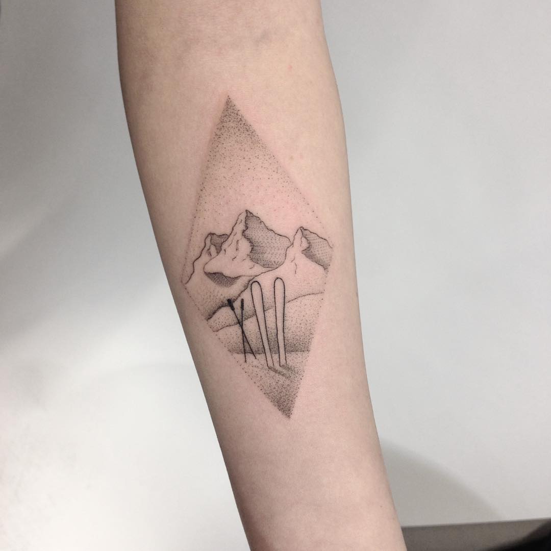 Mountains and skis tattoo