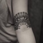 Ornamental lace tattoo on the arm