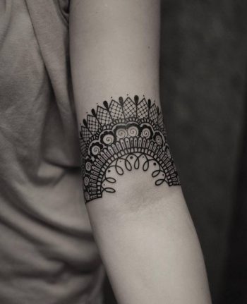 Ornamental lace tattoo on the arm