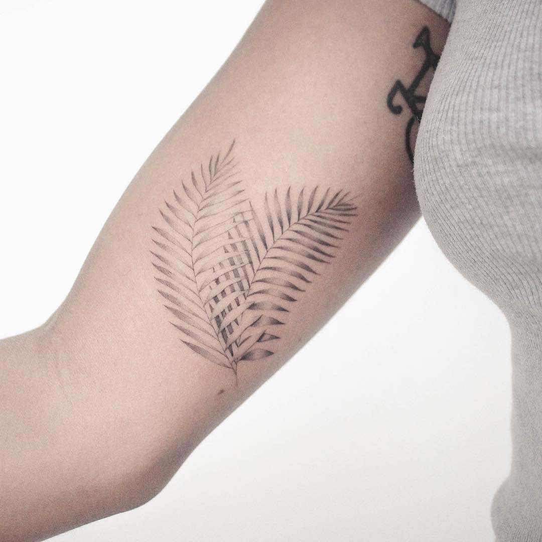 Palm leaves tattoo on the arm 