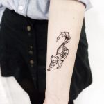 Polygonal cat tattoo on the forearm