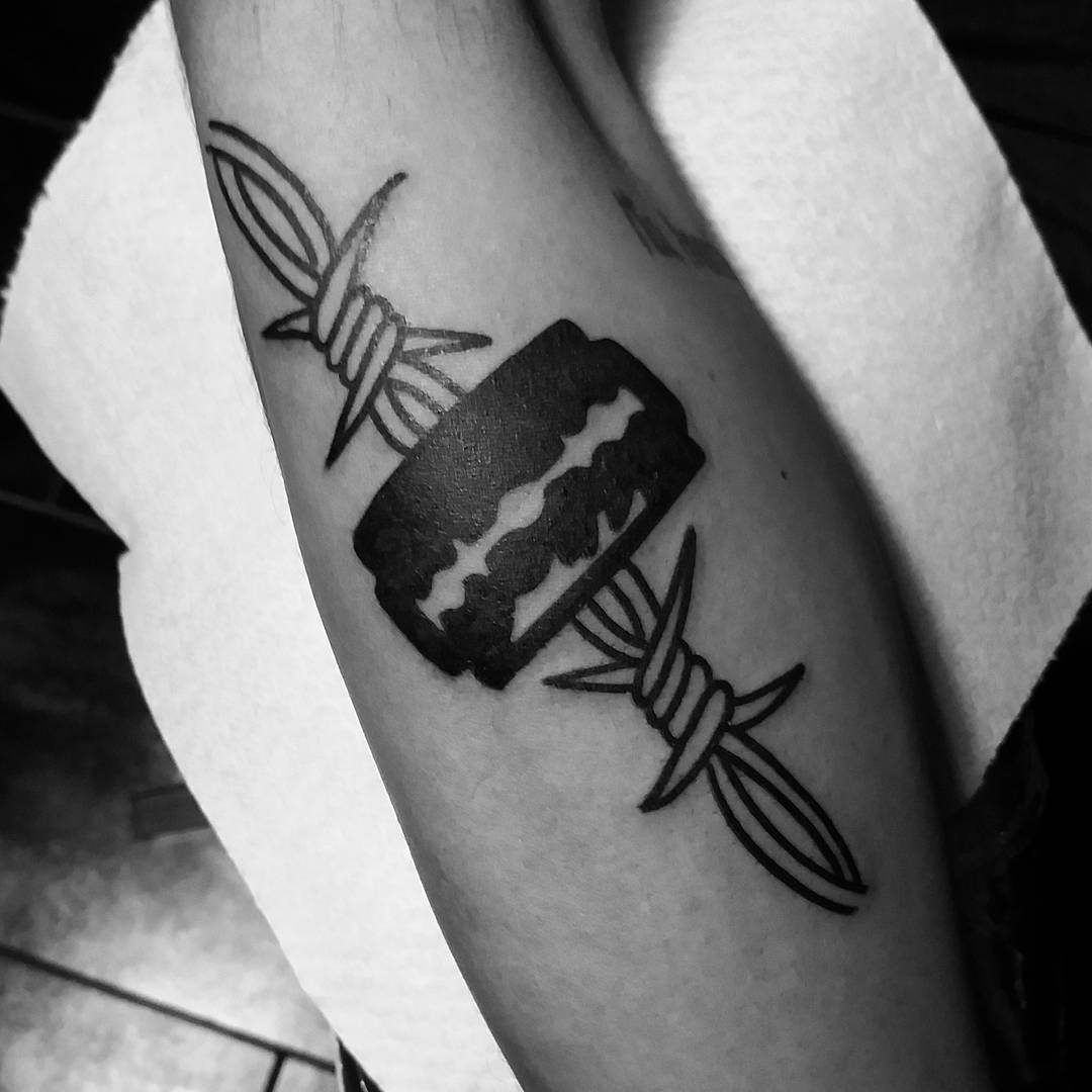 Razor blade and barbed wire tattoo