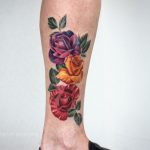 Red, yellow, and purple rose tattoo